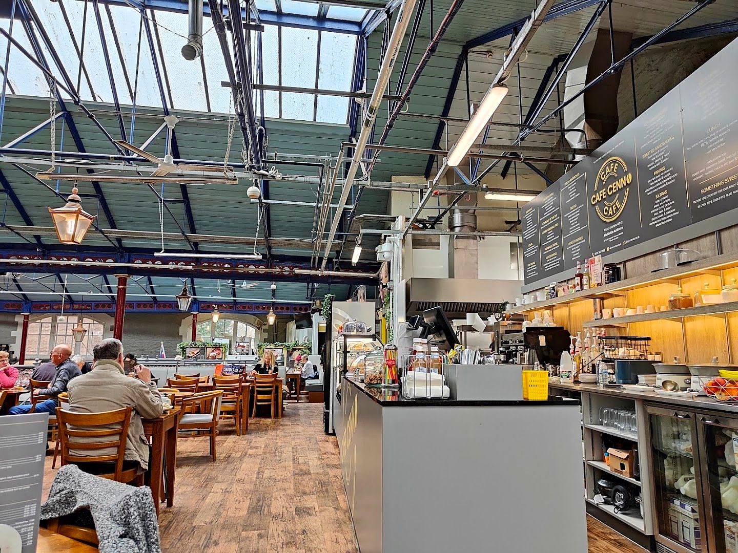 Inside Durham Market Hall: the glazed iron roof above Cafe Cenno's tables and counter